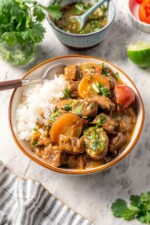 Carne guisada in a bowl with white rice.