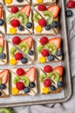 Overhead view of sugar cookie fruit pizza on sheet pan