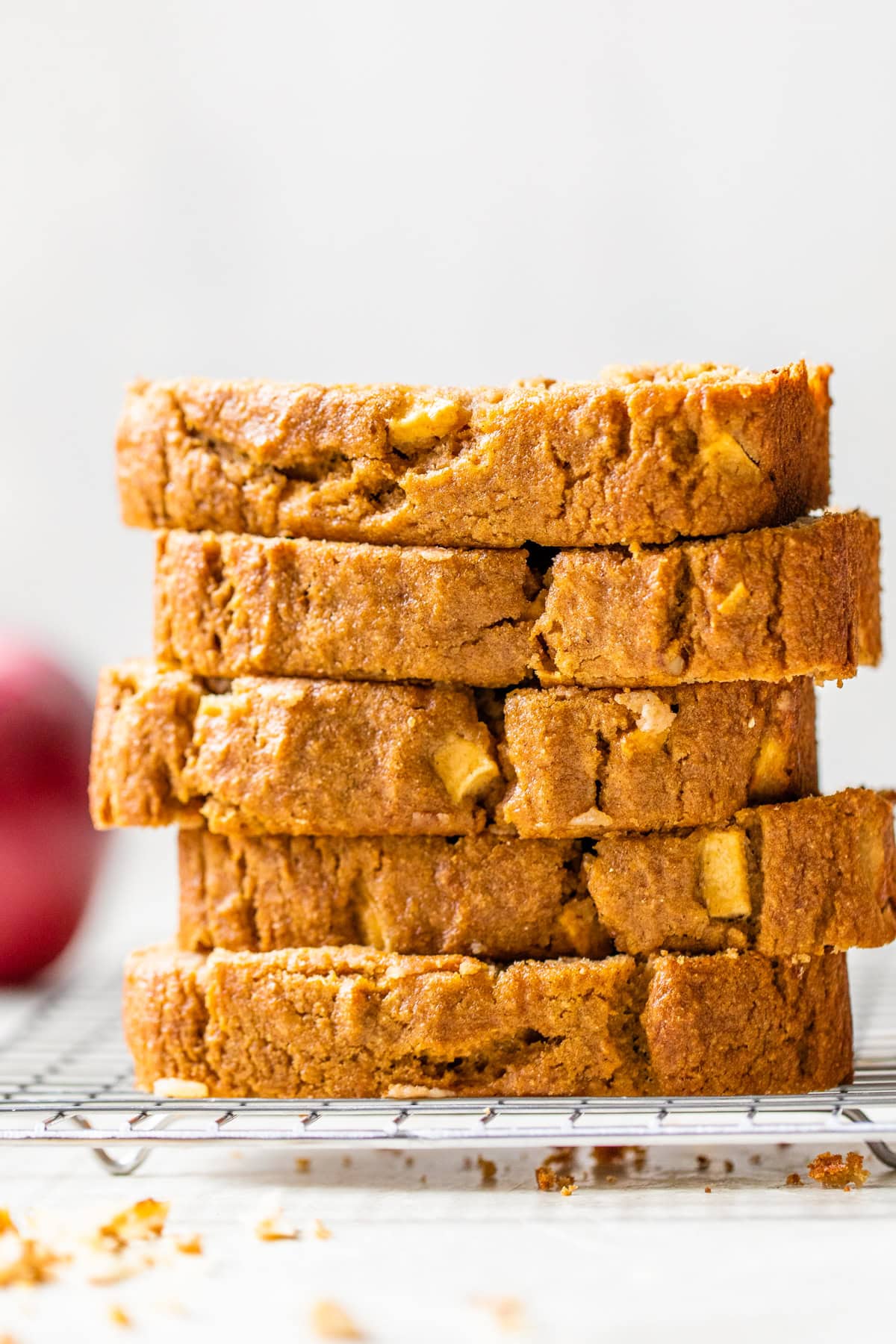 Moist apple bread recipe made with homemade applesauce, fresh apple chunks, spices, and walnuts in every bite. It's easy and so delicious! Slices of apple bread stacked.