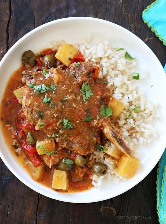 These slow cooker pork chops are seasoned with Latin spices in a flavorful sauce with tomatoes, olives, peppers and potatoes. They literally fall of the bone when they come out of the slow cooker!