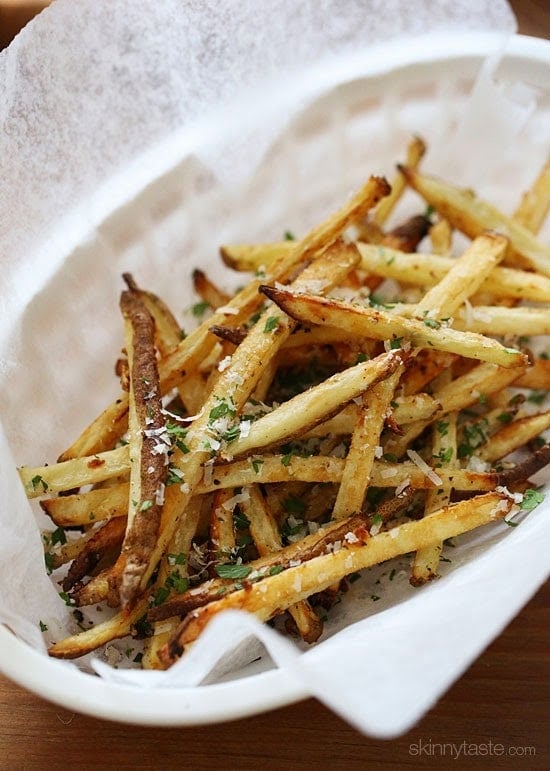 These delicious fries are baked in the oven with garlic, a little olive oil, kosher salt and black pepper, then sprinkled with freshly grated Parmesan and parsley – to die for!