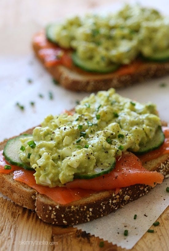 An open-faced egg salad sandwich with wild Nova salmon and cucumber slices – under 300 calories, protein packed, and loaded with good fats.