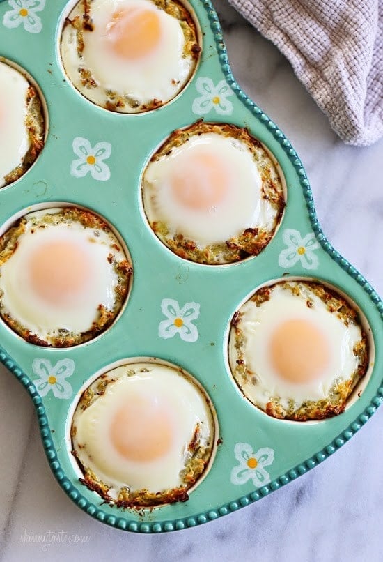 Baked Eggs in Spaghetti Squash Nests A muffin tin with a nest of spaghetti squash and a baked egg in each tin