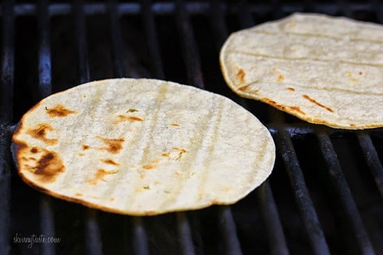 Two corn tortillas on a grill