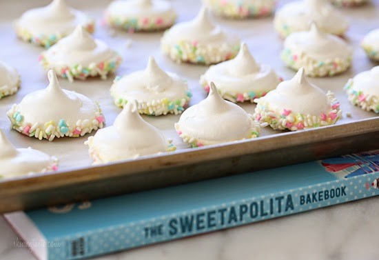Sprinkle Dipped Meringues Sprinkle Dipped Meringues – Melt-in-your-mouth meringues dipped in white chocolate and sprinkles!