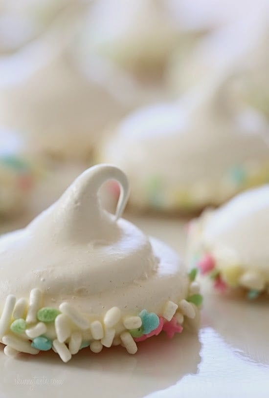 Sprinkle Dipped Meringues – Melt-in-your-mouth meringues dipped in white chocolate and sprinkles!