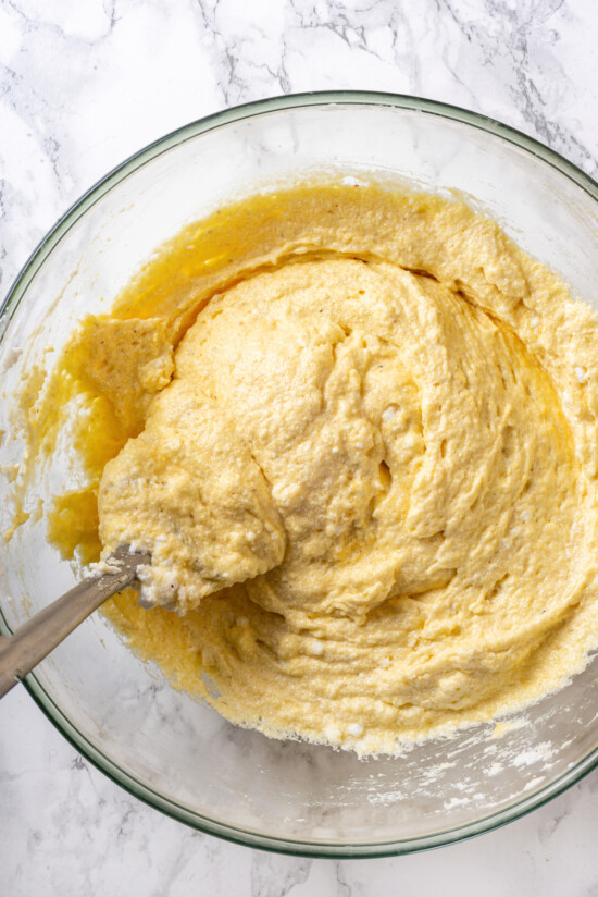 This easy almond cake recipe is made with just 5 ingredients but don't let its simplicity fool you—it's light, airy, and so delicious! Overhead view of almond cake batter in bowl