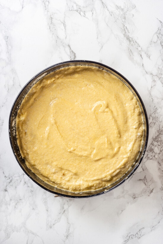 This easy almond cake recipe is made with just 5 ingredients but don't let its simplicity fool you—it's light, airy, and so delicious! Overhead view of almond cake batter in pan