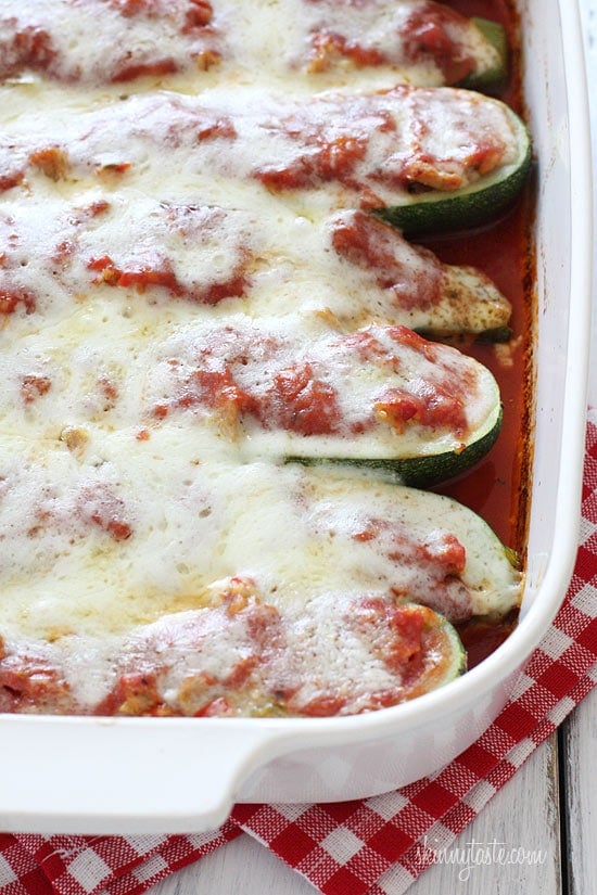 These Italian sausage stuffed zucchini boats are cheesy, flavorful, and a great way to turn summer zucchini into a satisfying dinner! Sausage stuffed zucchini boats baked in casserole dish.