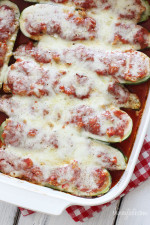 Sausage stuffed zucchini boats in casserole dish.