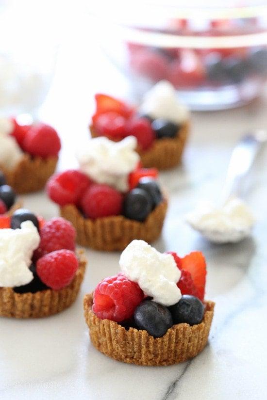 Mixed Berry Tartlet with Dark Chocolate and Vanilla Whipped Cream Perfect summer treat, these tartlets are made with a graham cracker crust, drizzled with dark chocolate and filled with fresh berries