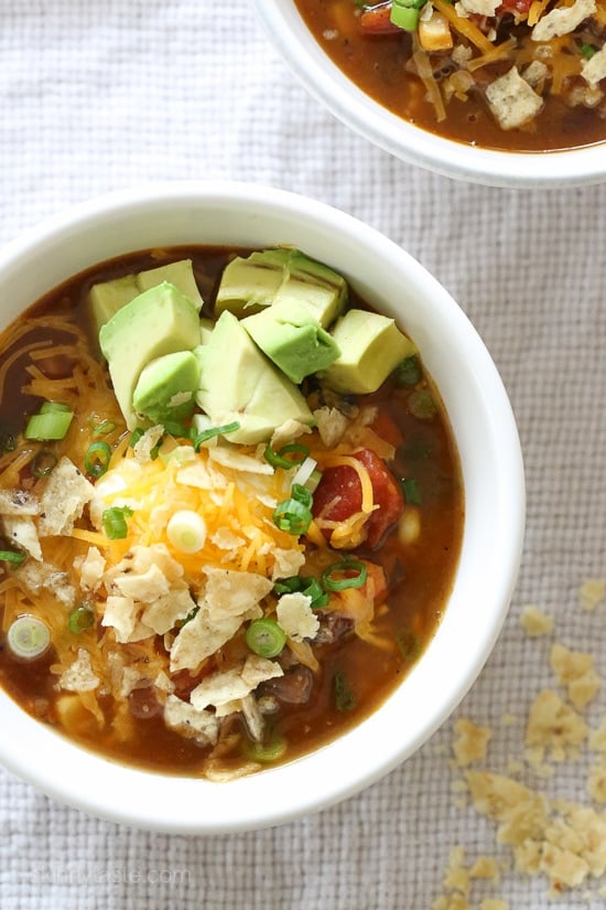 This Vegetarian Pumpkin Chili is loaded with pumpkin puree, veggies, beans, and a homemade spice blend. Hearty, filling, and oh-so-tasty! Overhead view of a bowl of pumpkin chili