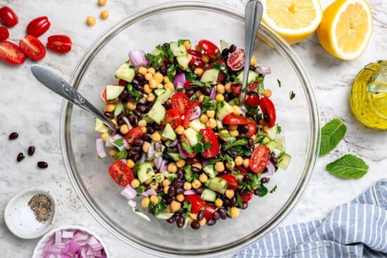 This easy garbanzo bean Mediterranean salad is fresh, simple, and full of flavor, made with minimal prep and wholesome ingredients. Garbanzo bean Mediterranean salad in glass mixing bowl.