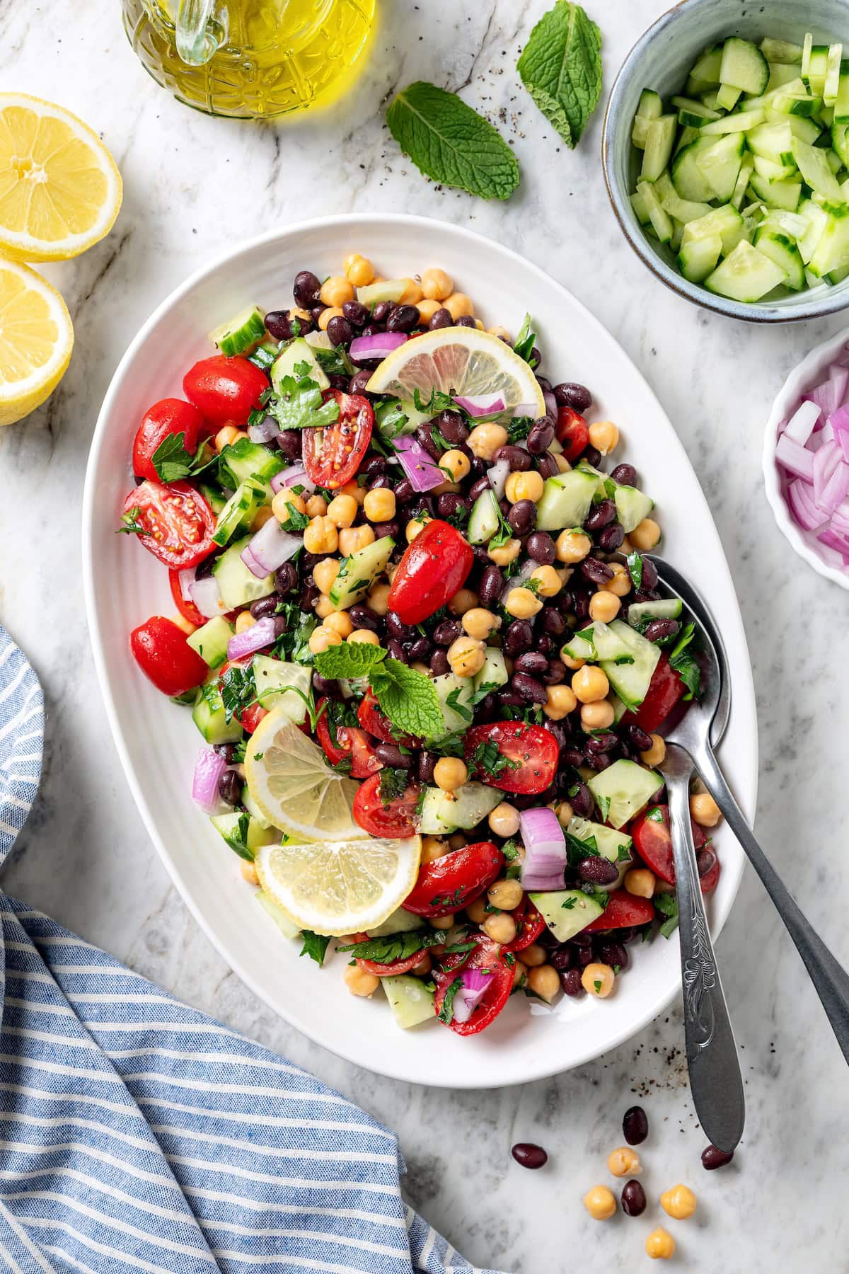 This easy garbanzo bean Mediterranean salad is fresh, simple, and full of flavor, made with minimal prep and wholesome ingredients. Garbanzo bean Mediterranean salad on serving platter.