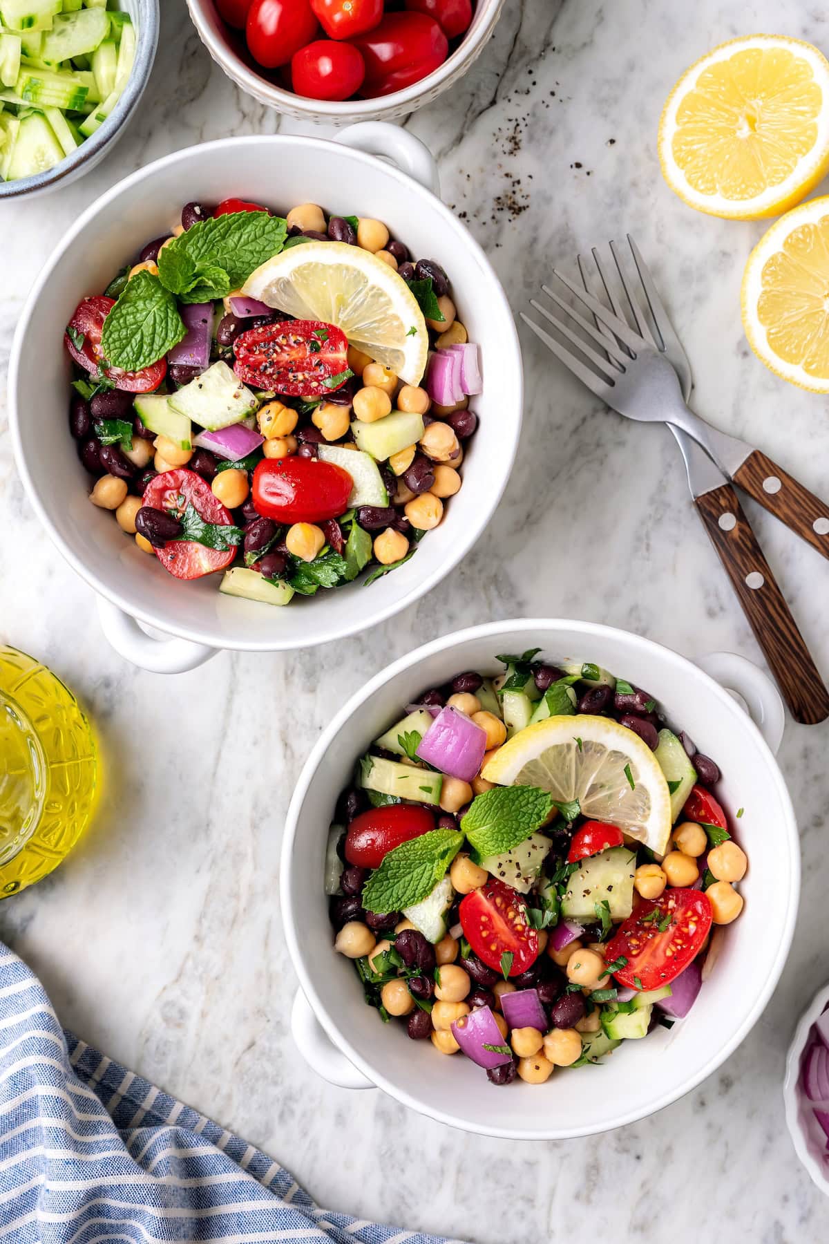 This easy garbanzo bean Mediterranean salad is fresh, simple, and full of flavor, made with minimal prep and wholesome ingredients. Garbanzo bean Mediterranean salad in two bowls.