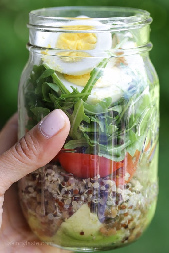 A protein-packed meatless salad in a jar made with quinoa, lentils, arugula, avocado and hard boiled eggs are perfect to pack for work, the beach, picnics, or anywhere you need a portable lunch on the go.
