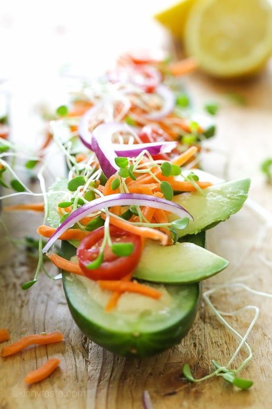 Cucumbers with the seeds scooped out and filled with hummus, avocado, tomatoes, onion and sprouts. So refreshing, healthy and light!