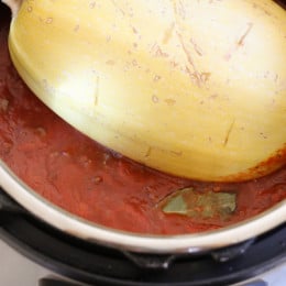 Make meat sauce AND Spaghetti Squash at the same time with this delicious one-pot meal ready in under thirty minutes (if using a pressure cooker)!