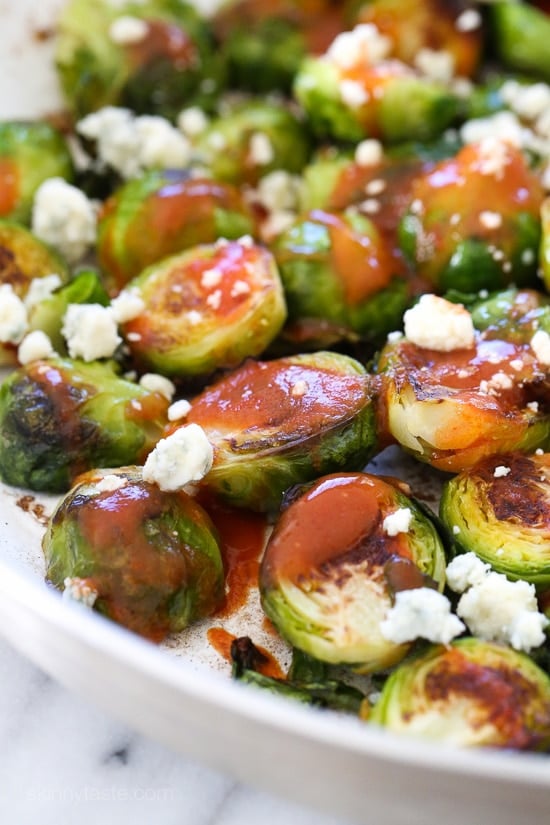 These Brussels sprouts start in the skillet and finish in the oven for perfectly charred edges, then drizzled with buffalo hot sauce and crumbled blue cheese – SO good!!
