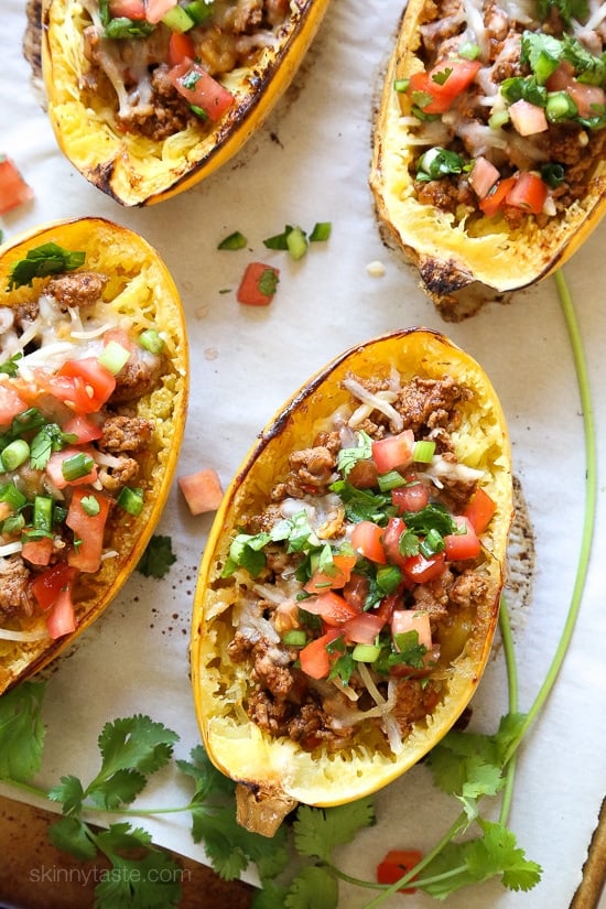 These Turkey Taco Spaghetti Squash Boats are my favorite way to eat spaghetti squash! Filled with the most flavorful turkey taco meat, cheese and topped with pico de gallo. #lowcarb #keto #whole30 #glutenfree #spaghettisquash #spaghettisquashrecipe