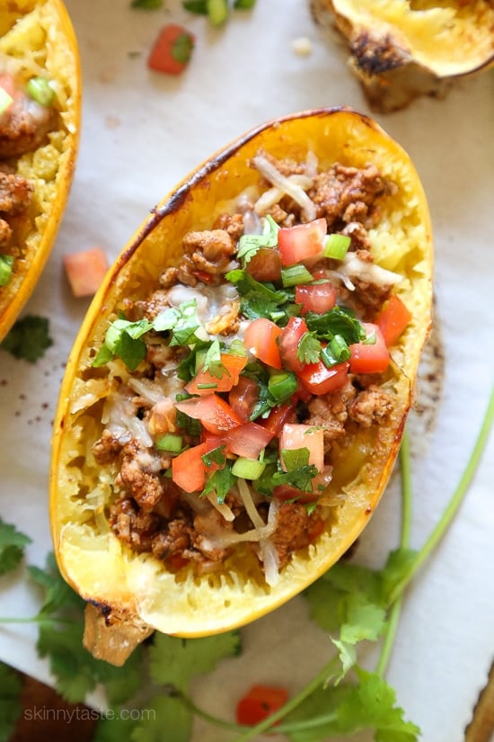 These Turkey Taco Spaghetti Squash Boats are my favorite way to eat spaghetti squash! Filled with the most flavorful turkey taco meat, cheese and topped with pico de gallo. #lowcarb #keto #whole30 #glutenfree #spaghettisquash #spaghettisquashrecipe