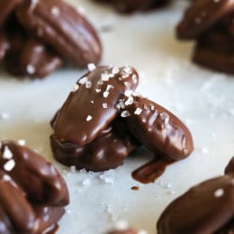 Almonds, pecans and walnuts are dipped in dark melted chocolate and finished with a touch of sea salt for the tastiest Holiday treats!