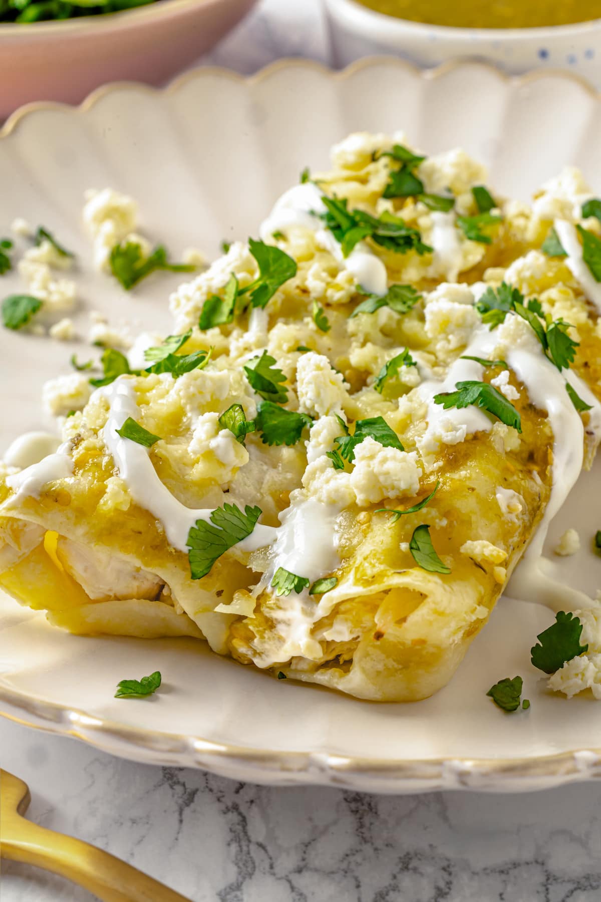 Two enchiladas verdes on a plate
