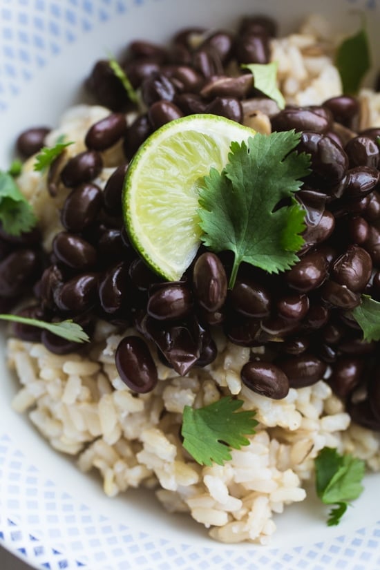 These Instant Pot Black Beans are flavored with warm spices, bacon, onion, garlic, and poblano pepper for a smoky but mild taste. Instant Pot black beans over rice