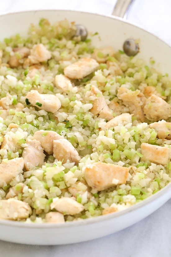Skillet Cheesy Chicken and Veggie "Rice" made with riced broccoli and cauliflower, sauteed chicken and cheddar cheese. It's so fast and easy to make!