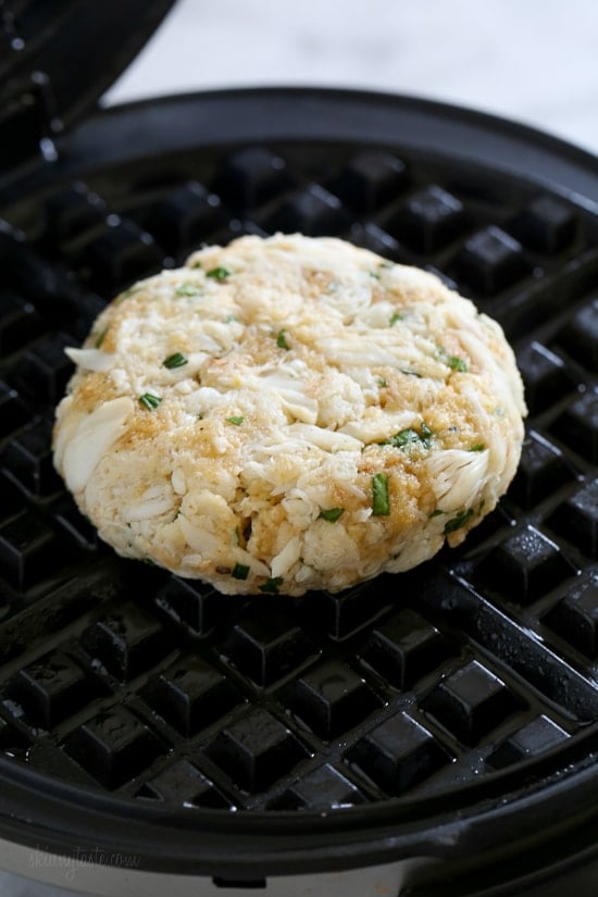 Dust off that waffle machine to make these fast and delicious Waffled Crab Cakes! This is so genius you're going to wonder why you haven't thought of this sooner. The crab cakes cook perfectly in the center, with golden edges in less than 3 minutes! And you get perfect little square pockets to hold the lemon juice or tartar sauce.