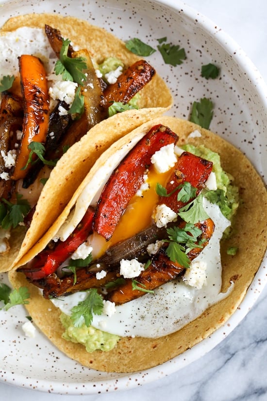 I just love tacos with eggs, and these breakfast fajitas are no exception. Loaded with peppers and onions, guacamole and a runny egg on top (you can prepare the eggs however you like).