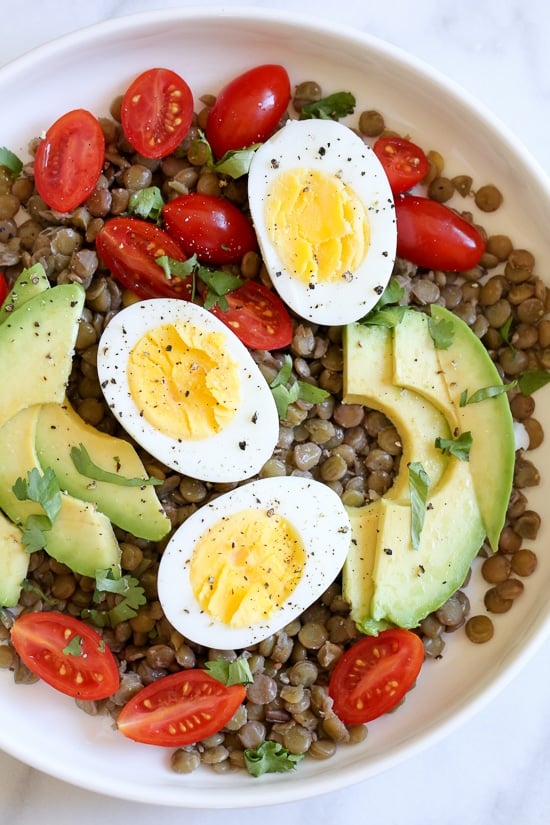Lentils with hard boiled eggs, tomatoes, avocado, a squeeze of lime juice, cilantro and a few dashes of hot sauce is a really simple meatless lunch I like to make for myself anytime I have cooked lentils (or sometimes I buy them cooked).