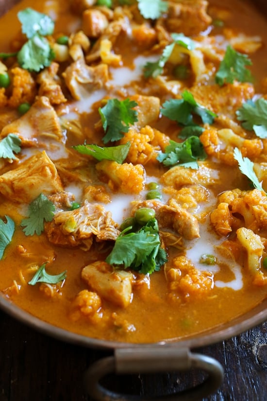 This Instant Pot Chicken Tikka Masala with cauliflower and peas is a lightened up, dairy-free version of the classic Indian curry. Angled view of Instant Pot chicken tikka masala with caulfilower