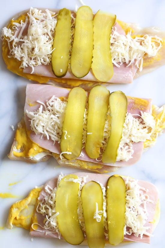 This Cubano Chicken Roll Up idea came to me after having a serious pickle craving! I wanted to make a hot dish utilizing dill pickles in some way and decided to stuff a chicken breast with everything you'd normally find in a Cuban Sandwich – pickles, mustard, Swiss, and ham. But I took it a step further and brined the cutlets overnight in pickle juice for extra flavor, the results were outstanding!!!