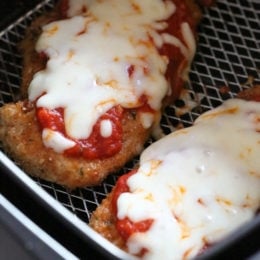 Close up of air fryer chicken parmesan inside the air fryer basket.