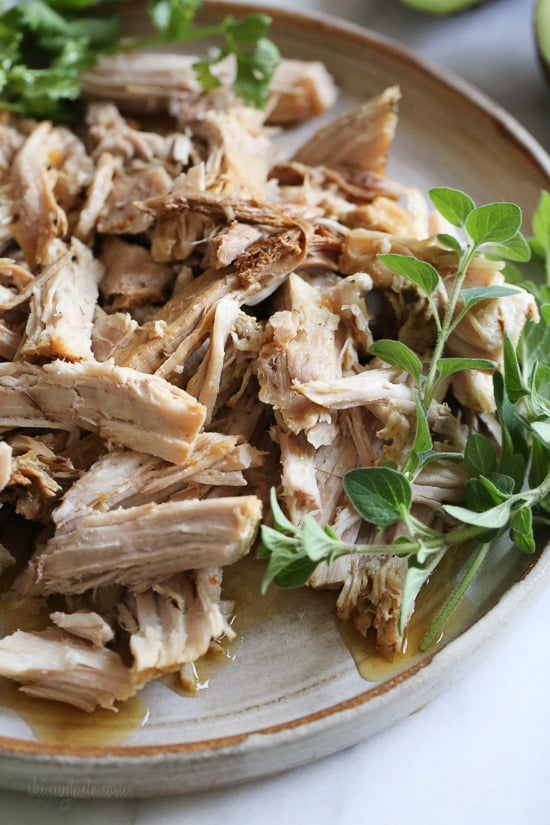 This Instant Pot Cuban Pork Recipe features tender shredded pork marinated in a garlic, cumin and citrus marinade, then cooked to perfection. Instant pot Cuban pork on a plate