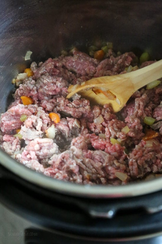 Instant Pot Bolognese sauce is full of flavor and ready in one hour! See how easy it is to make a classic meat sauce in your pressure cooker. Ground beef added to the Instant Pot with sauteed vegetables.