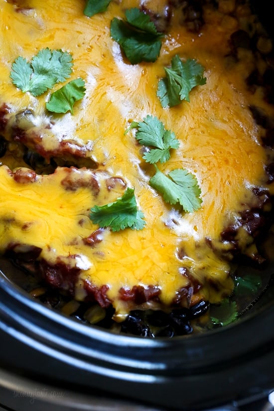 This EASY Slow Cooker Chicken dish is cheesy and delicious, made with boneless chicken breast, black beans, corn and salsa topped with melted cheddar cheese. YUM!