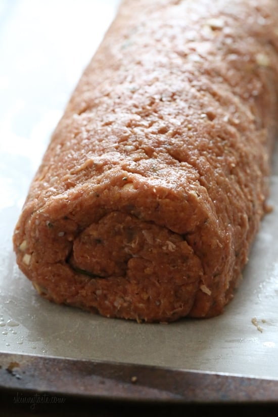 The best tasting, moist turkey meatloaf stuffed with cheddar cheese, spinach and rolled, jelly roll style topped with a ketchup based glaze.