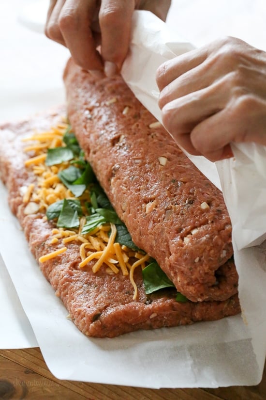 The best tasting, moist turkey meatloaf stuffed with cheddar cheese, spinach and rolled, jelly roll style topped with a ketchup based glaze.