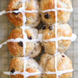 Overhead view of hot cross buns topped with icing.