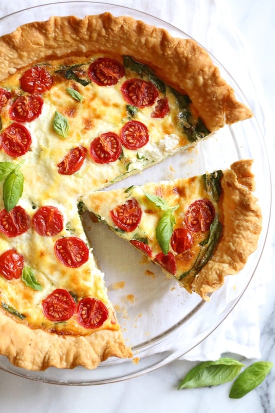 This easy vegetarian quiche recipe is made with spinach, ricotta cheese, eggs, tomatoes and basil. Perfect for breakfast, lunch or brunch or serve it with a salad for a light dinner.