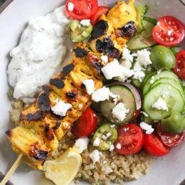 Smoky yogurt-marinated grilled chicken served over quinoa and Mediterranean-inspired tomatoes, cucumbers, and olives with tzatziki and Feta.