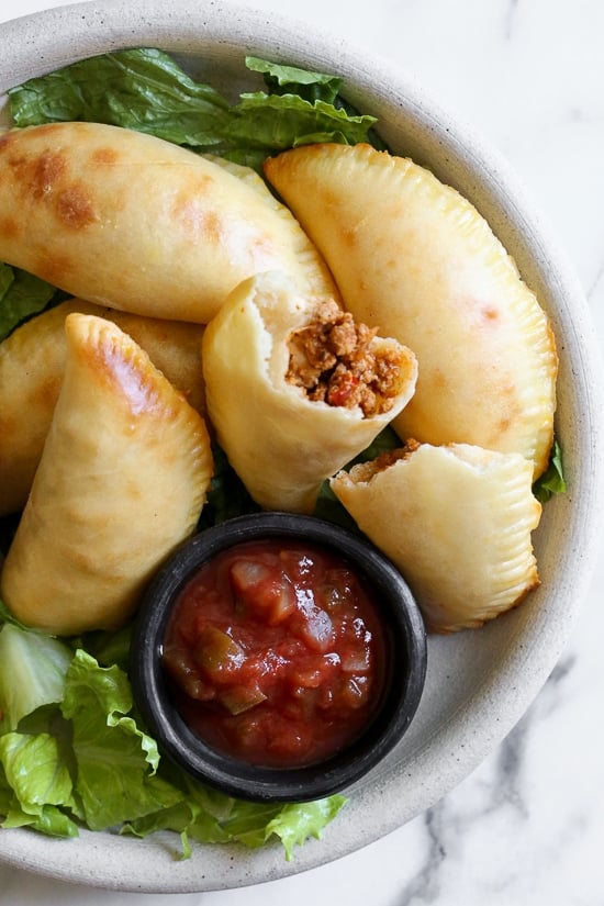 These taco empanadas are made from scratch with my ground turkey taco recipe and my quick and easy pizza dough recipe!