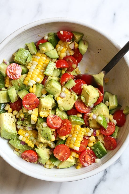 This Corn Tomato Avocado Salad is summer in a bowl! The perfect side dish with anything you're grilling, or double the portion as a main dish.