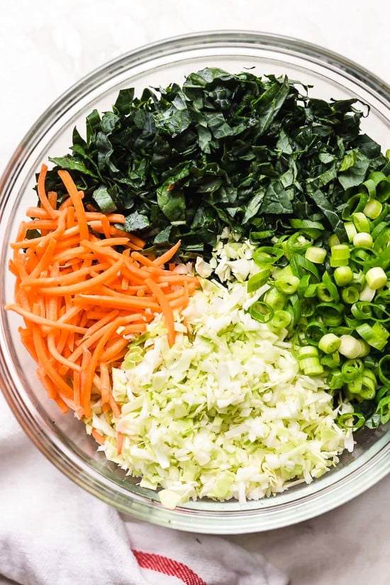 Houston’s (Lightened-Up) Kale Salad with Peanut Vinaigrette is satisfying, made with a combo of grilled chicken, kale, cabbage, carrots, peanuts, scallions, cilantro and mint tossed in a light peanut-sesame dressing.