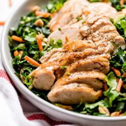 Houston’s (Lightened-Up) Kale Salad with Peanut Vinaigrette is satisfying, made with a combo of grilled chicken, kale, cabbage, carrots, peanuts, scallions, cilantro and mint tossed in a light peanut-sesame dressing.