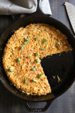 Hash browns in skillet with portions removed
