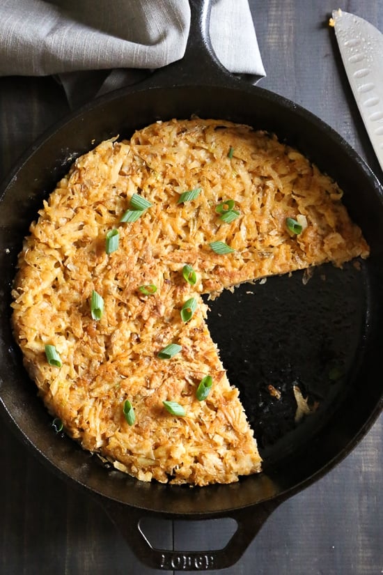 Hash browns in skillet with portions removed