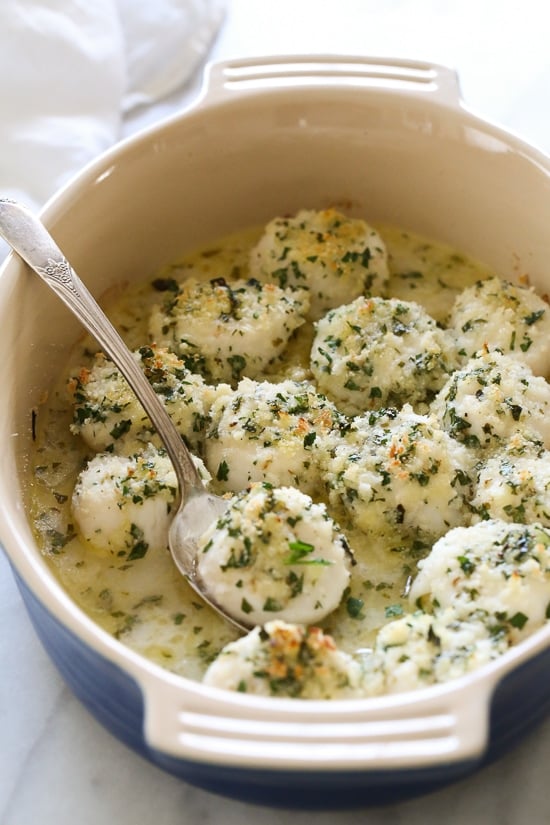 These quick and easy baked sea scallops are topped with panko and Parmesan in a simple lemon-butter sauce.